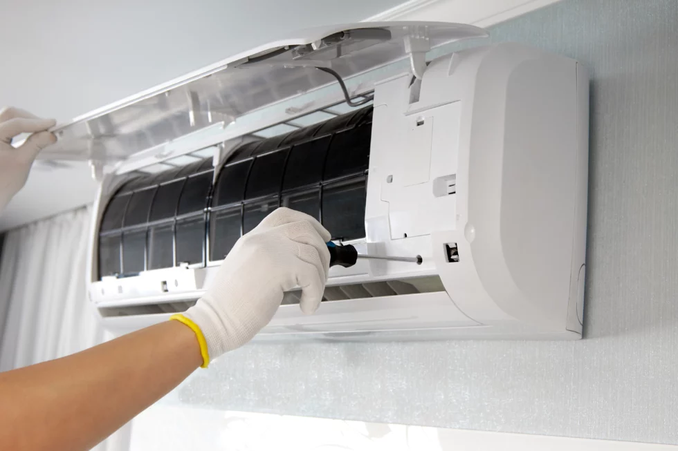 hands-male-technician-repairing-indoor-air-conditioner-using-screwdriver-maintenance-air-conditioners-980x653